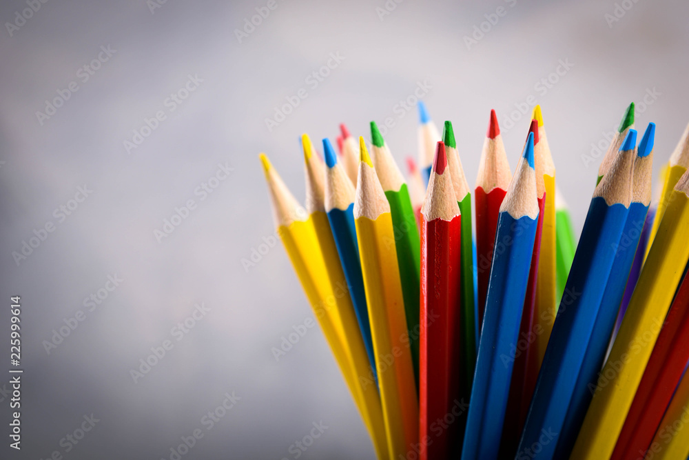Pencils colorul color wooden pencil in metal holder in front of wall background