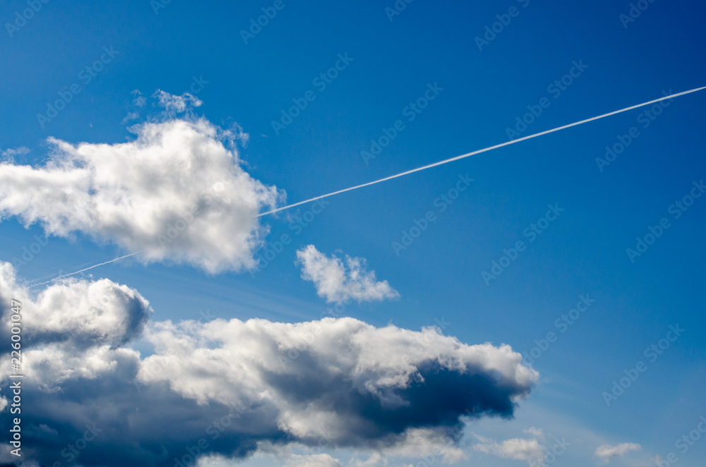 Large passenger supersonic plane flying high in clear blue sky, leaving long white trail Large passenger supersonic plane flying high in clear blue sky, leaving long white trail
