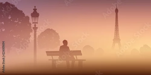 Fototapeta samoprzylepna W Paryżu mężczyzna medytuje samotnie na Champ de Mars, mglisty poranek siedząc na ławce przed Wieżą Eiffla