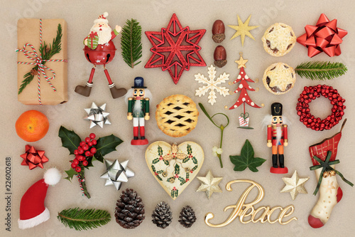 Christmas decorations with peace sign, food, flora, bows and traditional symbols forming an abstract background. Festive Christmas card for the holiday season. Top view.