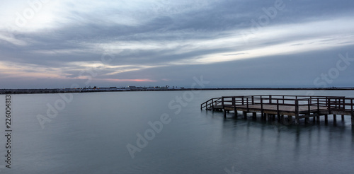 Long exposure of wooden pier at sunrise with lake © F.C.G.