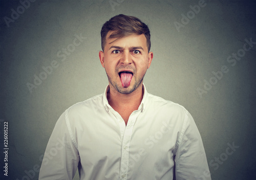 portrait of a man sticking his tongue out photo