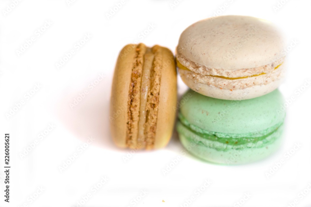 Colorful french macaroons on the blue table close up view