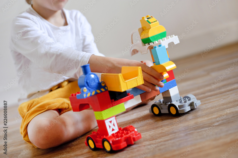 Fototapeta premium Boy plays designer. Child playing with blocks