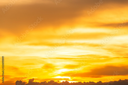 Orange sky background texture with white clouds sunset.