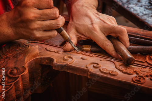 Fotografia, Obraz Carving and polishing of mahogany furniture