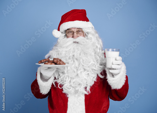Santa claus with cookie and milk at studio shot