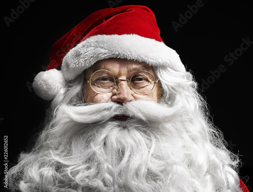 Obraz na plátně Santa claus's human face on  black background