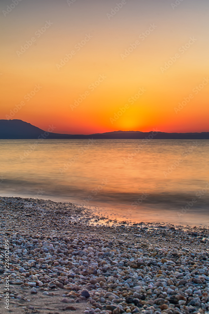 Fototapeta premium Early morning , dramatic sunrise over sea and mountain. Photographed in Asprovalta, Greece.