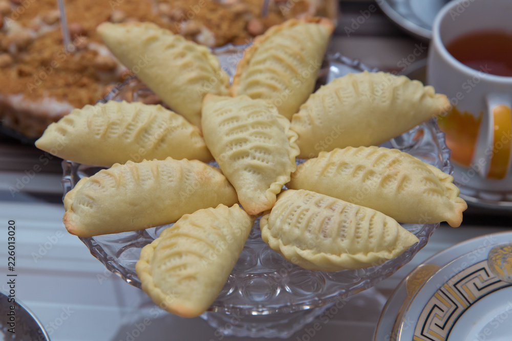 Traditional Azerbaijani sweet shekerbura shakarbura sybmol of Novruz holiday . Novruz tray with traditional Azerbaijan pastries shekerbura . Shekerbura baked during the spring holiday .