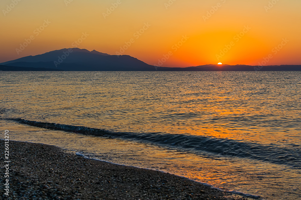 Fototapeta premium Early morning , dramatic sunrise over sea and mountain. Photographed in Asprovalta, Greece.
