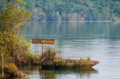 Crocodile warning sign at Laguna Lachua lake, Guatemala photo