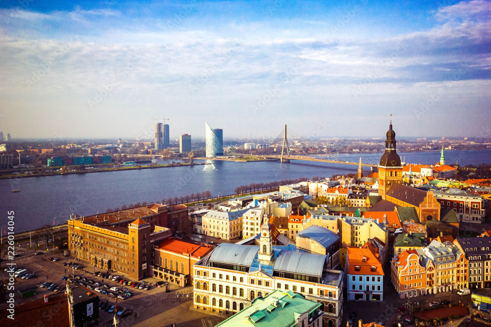 Panoramic view of old town with bright colorful houses and Riga Dome Cathedral, bridge over Dvina river in Riga, Latvia. Beautiful cityscape, top view.