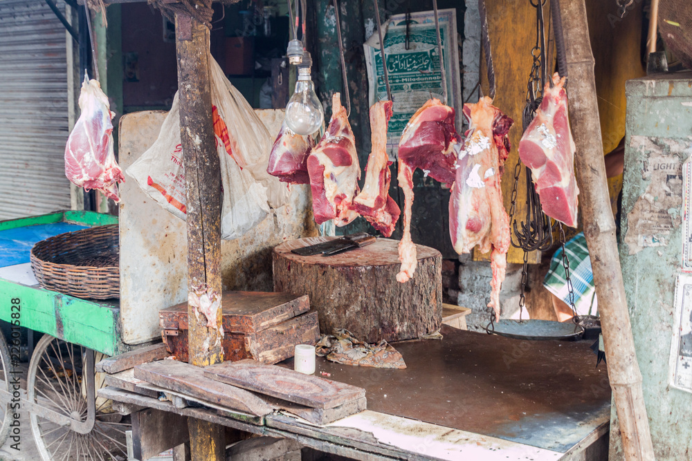 KOLKATA, INDIA - OCTOBER 30, 2016: Street butcher stall with hanging meat in the center of Kolkata, India
