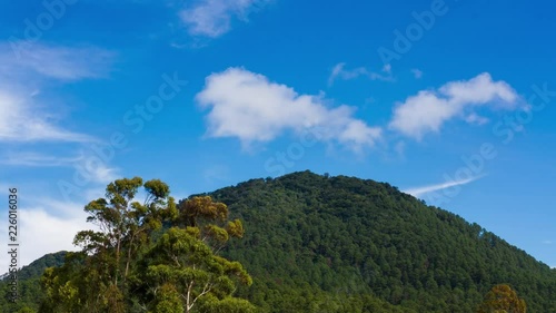 A time lapse of a mountain with clear skies. photo