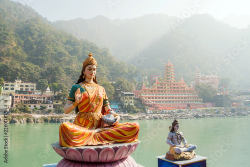 Statue of sitting goddess Parvati and Statue Shiva on the riverbank of Ganga in Rishikesh. photo