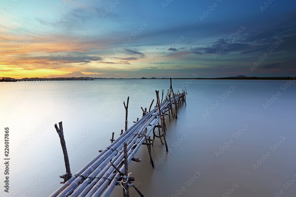 Bamboo pier bridge at beautiful sunset. soft focus due to long exposure Bamboo pier bridge at beautiful sunset. soft focus due to long exposure