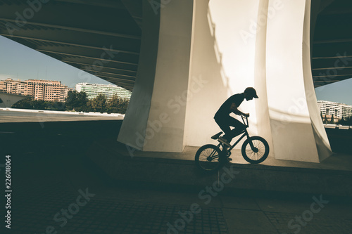 Guy riding a bmx bike on the street. Freestyle BMX in the city
