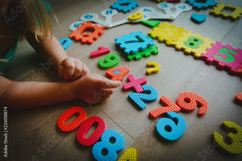 little girl learning numbers and math, play with puzzle