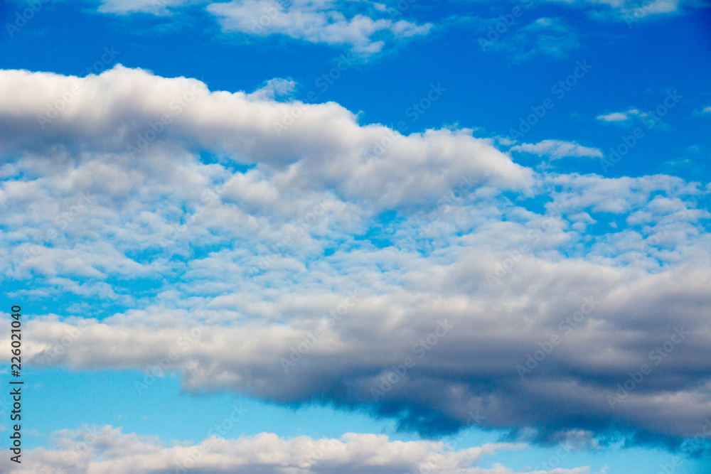 Snow-white light cumulus clouds against a blue sky Snow-white light cumulus clouds against a blue sky