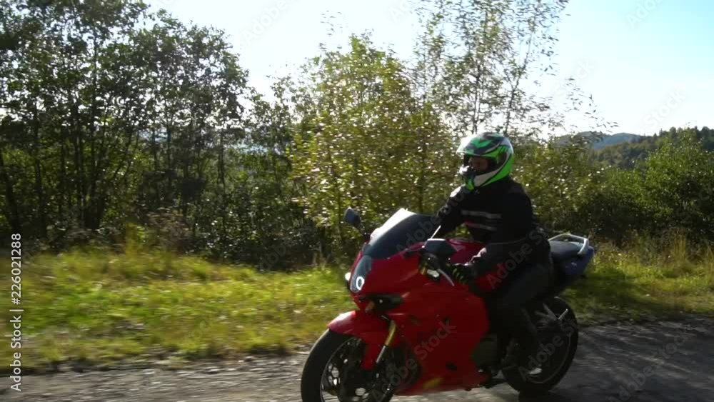 A guy on a motorcycle. Young handsome guy rides a motorcycle on a mountain road. A guy on a motorcycle. Young handsome guy rides a motorcycle on a mountain road.