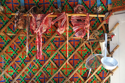 Raw meat, dried goat meat in the kitchen, Mongolian yurt inside with chintz style of his village