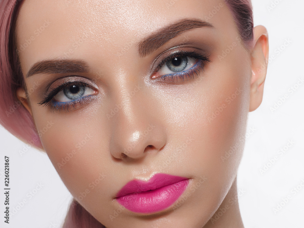 Close-up of woman's lips with fashion bright pink make-up. Beautiful female mouth, full lips with perfect makeup. Part of female face. Choice lipstick. Pink wavy hair of a Barbie doll Close-up of woman's lips with fashion bright pink make-up. Beautiful female mouth, full lips with perfect makeup. Part of female face. Choice lipstick. Pink wavy hair of a Barbie doll