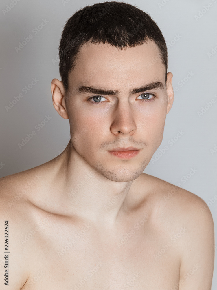 Beautiful strong face male model in fashion cloathes on white isolated font background Beautiful strong face male model in fashion cloathes on white isolated font background