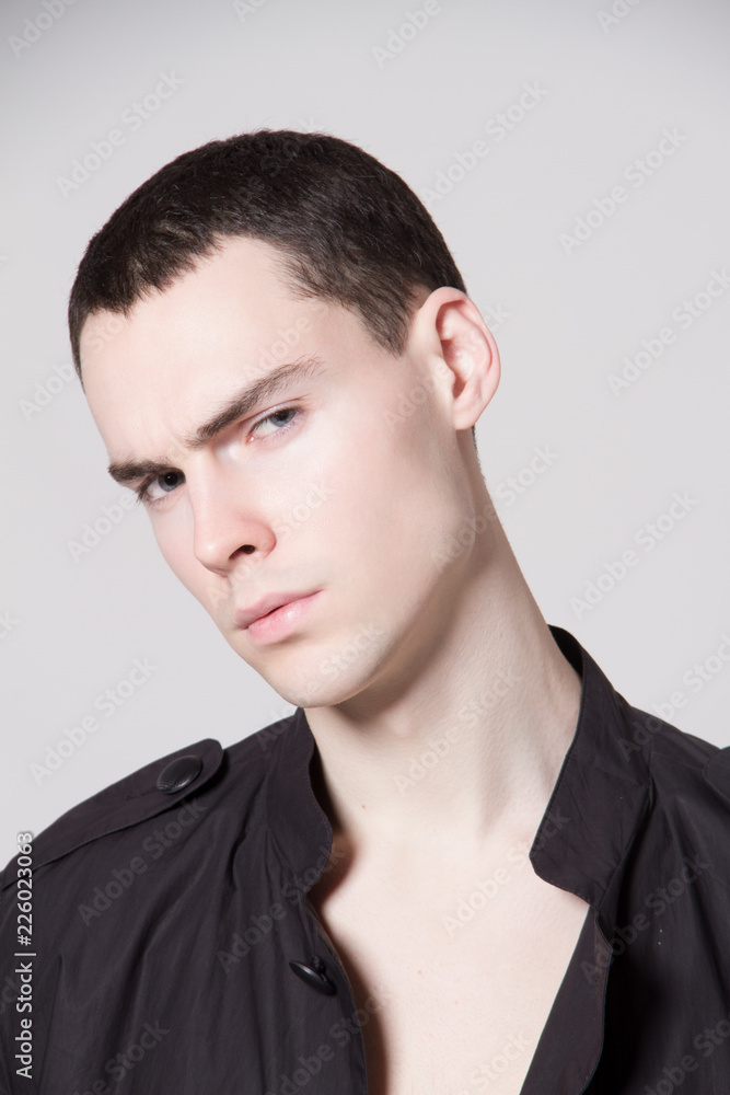 Beautiful strong face male model in fashion cloathes on white isolated font background Beautiful strong face male model in fashion cloathes on white isolated font background