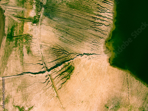 Abstract patterns of the earth and lake around the opencast mine photo