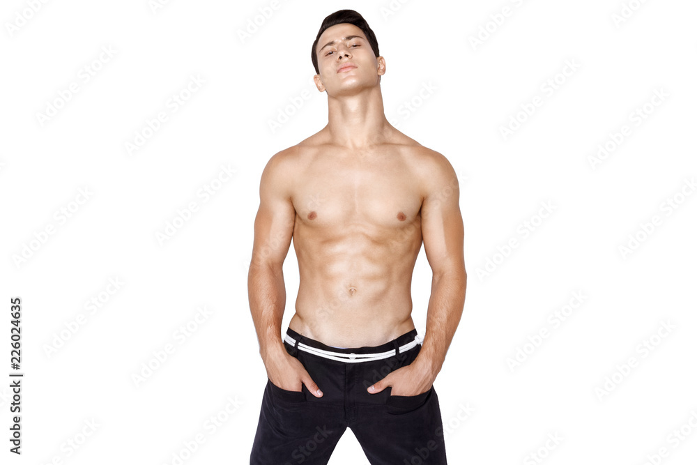 Fototapeta premium Strong muscle beautiful stripped male model in fashion cloathes on white isolated fontk background