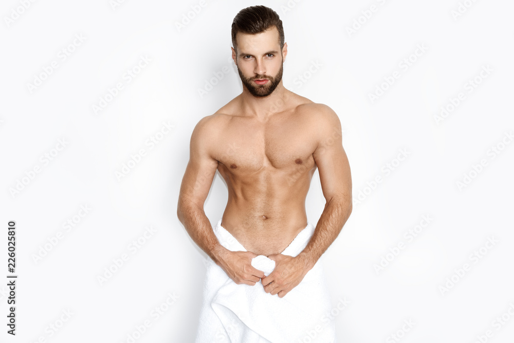 Sexy strong face sport muscle guy with white towel on white isolated font background Sexy strong face sport muscle guy with white towel on white isolated font background