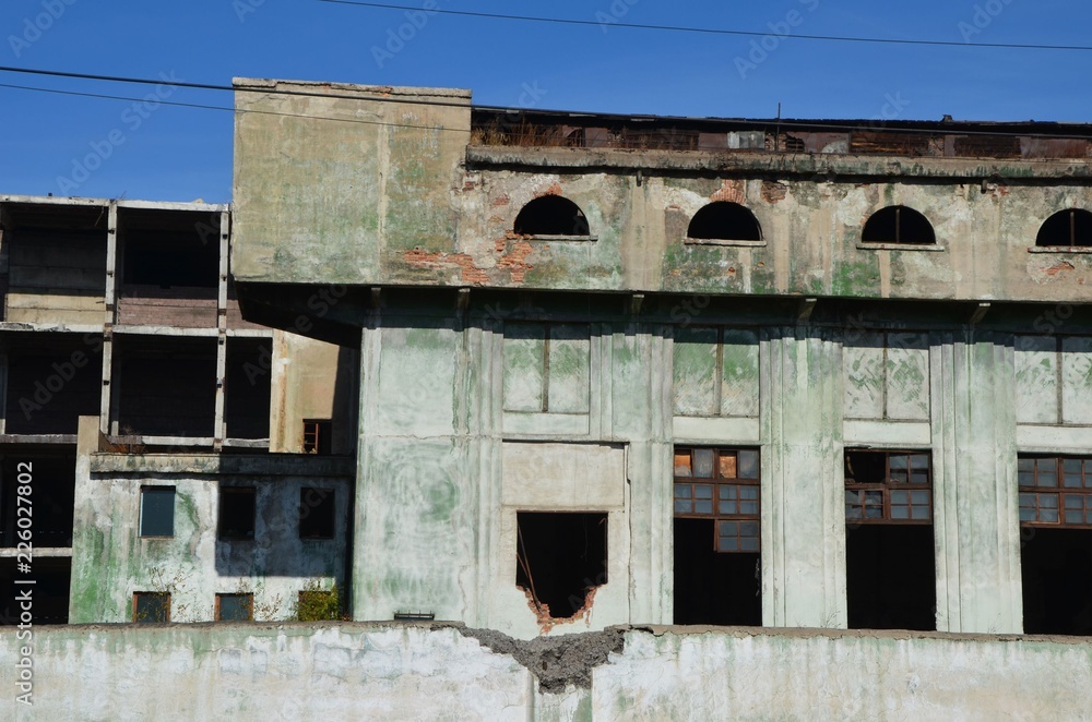 A frontal view of deserted foundry windows zoomed