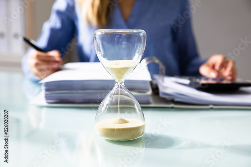 Close-up Of A Hourglass On Desk