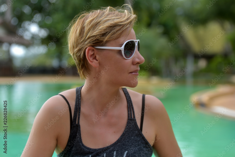 blond woman 30 years old with a short haircut in sunglasses blond woman 30 years old with a short haircut in sunglasses