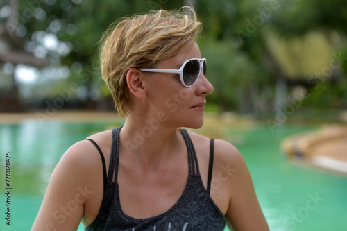 blond woman 30 years old with a short haircut in sunglasses