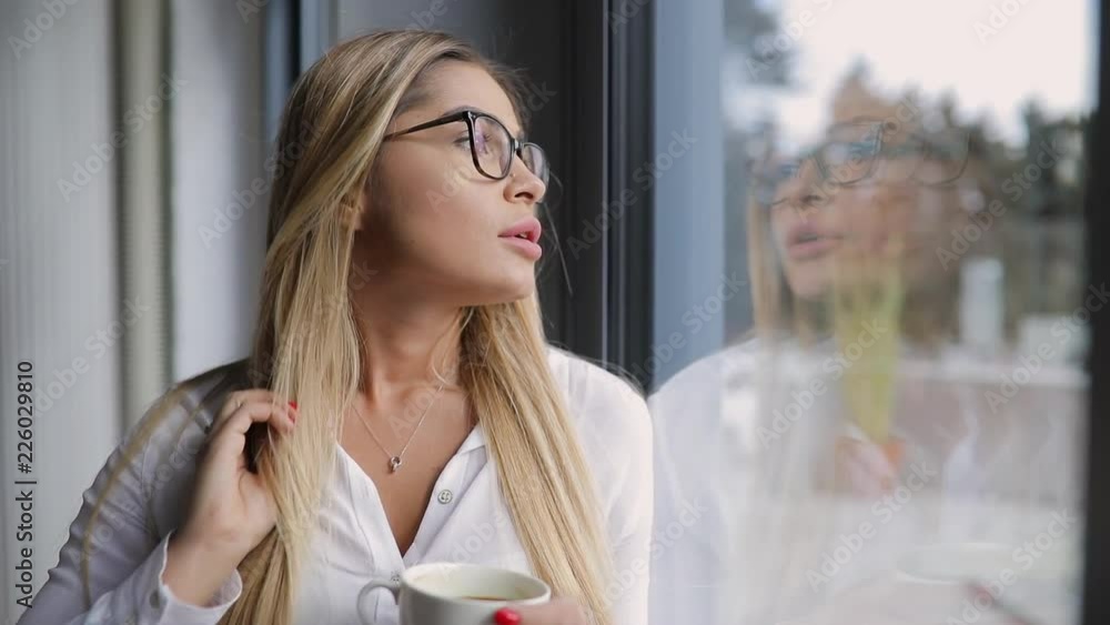 Pretty woman thinking in a cafe looking through window Pretty woman thinking in a cafe looking through window