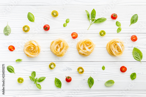 Ingredients for homemade pasta on wooden background.