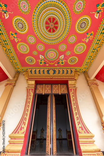 Ornate entrance to the Hor Dhammasabha Buddhist convention hall of Wat That Luang Neau Temple in Vientiane, Laos. photo