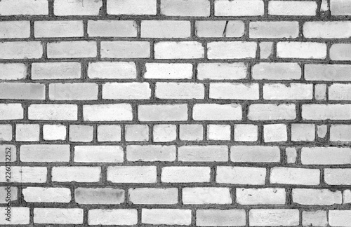 Grungy weahered brick wall in black and white.