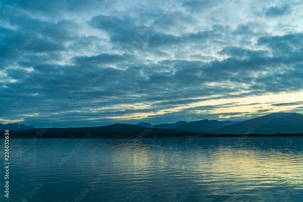 View of the fjord from Tromso on the island of Tromsoja, Norway during sunset
