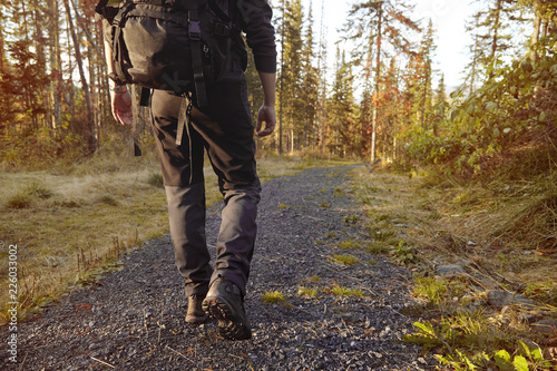 Female hiker with backpack in the forest.
