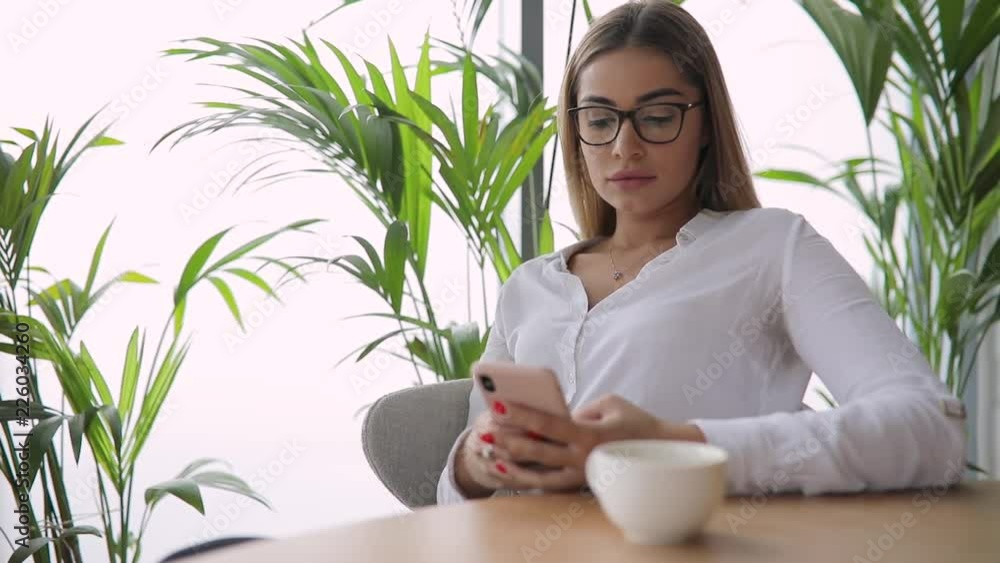 Sexy attractive woman in eyeglasses looking at me after using mobile Sexy attractive woman in eyeglasses looking at me after using mobile