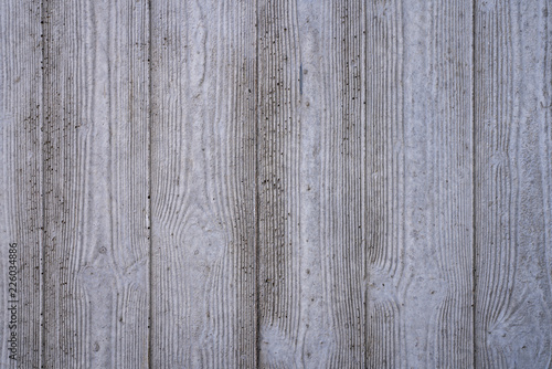 wood grain imprints in a concrete wall for backgrounds