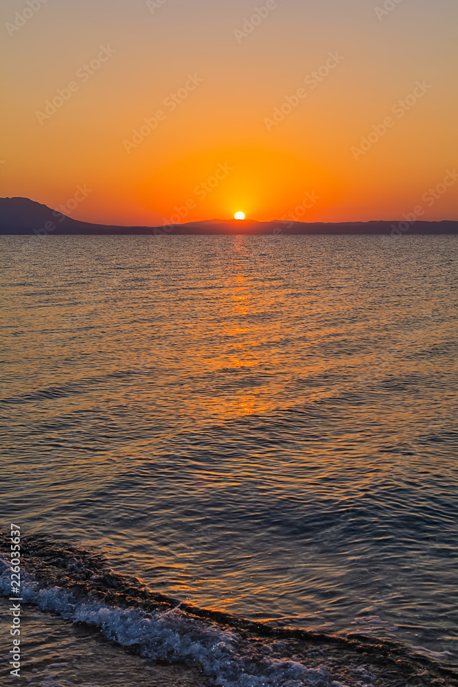 Fototapeta premium Early morning , dramatic sunrise over sea and mountain. Photographed in Asprovalta, Greece.