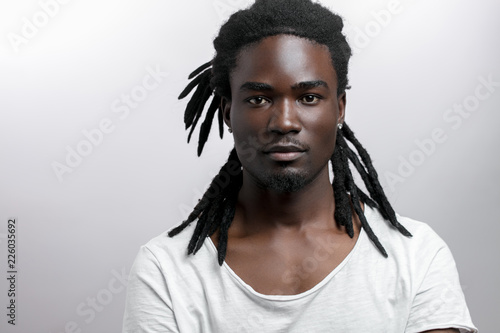 Photography African American male with dreadlocks on white background looking at camera