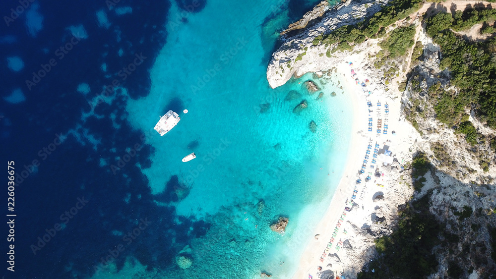 Obraz premium Aerial drone photo of iconic paradise sandy beach of Agiofili near port of Vasiliki with emerald crystal clear sea and sail boats docked, Lefkada island, Ionian, Greece
