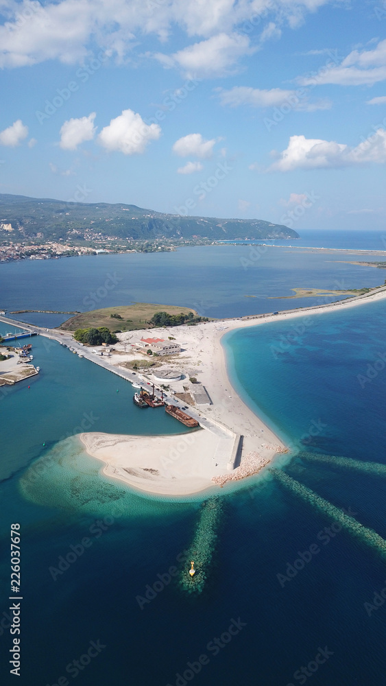 Obraz premium Aerial drone bird's eye view of famous and exotic sand tongue beach with clear emerald waters near castle of Santa Mavra in entrance of Lefkada island, Ionian, Greece