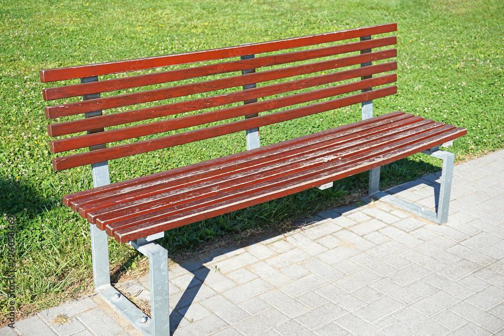 Park bench next to a grass area