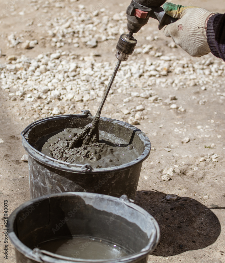 Mixing of concrete in a bucket at a construction site Mixing of concrete in a bucket at a construction site